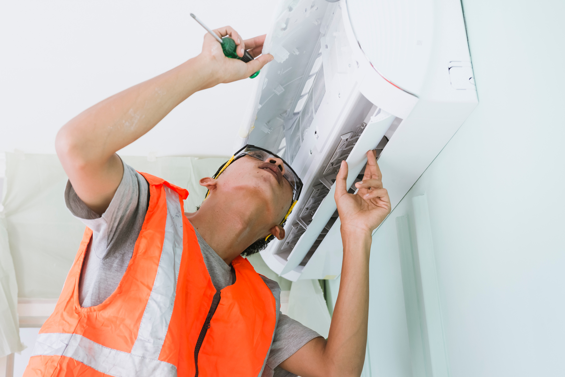 Man Repairing the Air Conditioning Unit